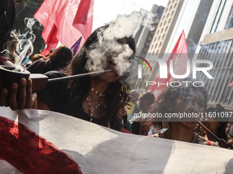 Protesters hold a demonstration against the fires and the climate situation in Brazil and for agrarian reform on Avenida Paulista, in the ce...