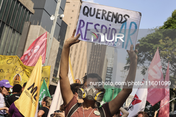 Protesters hold a demonstration against the fires and the climate situation in Brazil and for agrarian reform on Avenida Paulista, in the ce...