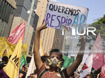 Protesters hold a demonstration against the fires and the climate situation in Brazil and for agrarian reform on Avenida Paulista, in the ce...