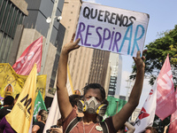 Protesters hold a demonstration against the fires and the climate situation in Brazil and for agrarian reform on Avenida Paulista, in the ce...