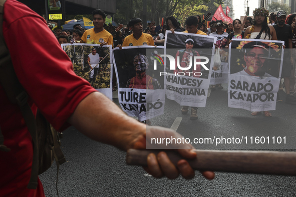 Protesters hold a demonstration against the fires and the climate situation in Brazil and for agrarian reform on Avenida Paulista, in the ce...