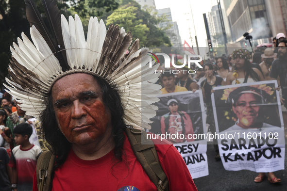 Protesters hold a demonstration against the fires and the climate situation in Brazil and for agrarian reform on Avenida Paulista, in the ce...