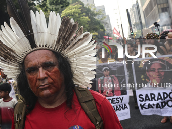 Protesters hold a demonstration against the fires and the climate situation in Brazil and for agrarian reform on Avenida Paulista, in the ce...