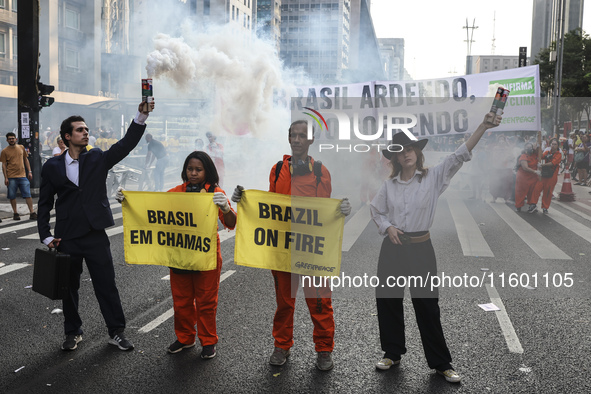 Protesters hold a demonstration against the fires and the climate situation in Brazil and for agrarian reform on Avenida Paulista, in the ce...