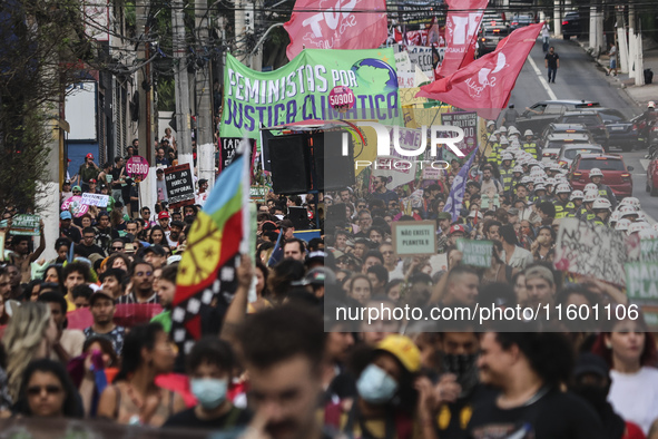 Protesters hold a demonstration against the fires and the climate situation in Brazil and for agrarian reform on Avenida Paulista, in the ce...