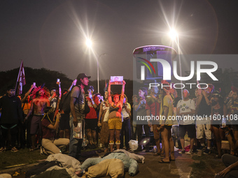 Protesters hold a demonstration against the fires and the climate situation in Brazil and for agrarian reform on Avenida Paulista, in the ce...