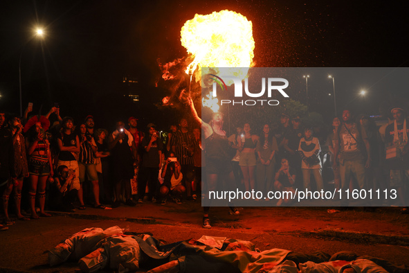 Protesters hold a demonstration against the fires and the climate situation in Brazil and for agrarian reform on Avenida Paulista, in the ce...