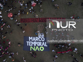 Protesters hold a demonstration against the fires and the climate situation in Brazil and for agrarian reform on Avenida Paulista, in the ce...