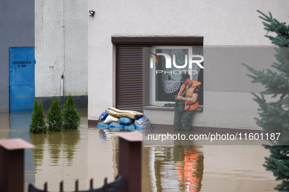 A man stands in the water after Nysa Klodzka river flooded town of Lewin Brzeski in southwestern Poland, on September 19th, 2024. Storm Bori...