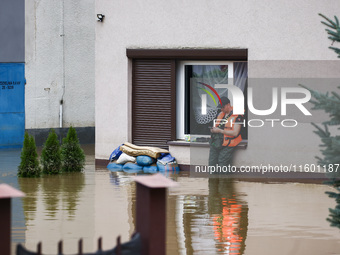 A man stands in the water after Nysa Klodzka river flooded town of Lewin Brzeski in southwestern Poland, on September 19th, 2024. Storm Bori...