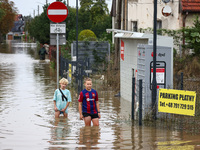 Children walk in the water after Nysa Klodzka river flooded town of Lewin Brzeski in southwestern Poland, on September 19th, 2024. Storm Bor...