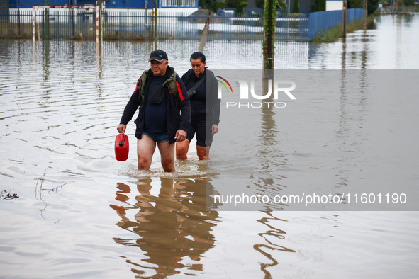 Residents walk in the water after Nysa Klodzka river flooded town of Lewin Brzeski in southwestern Poland, on September 19th, 2024. Storm Bo...