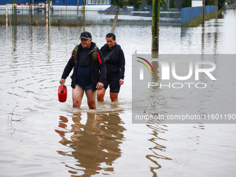 Residents walk in the water after Nysa Klodzka river flooded town of Lewin Brzeski in southwestern Poland, on September 19th, 2024. Storm Bo...