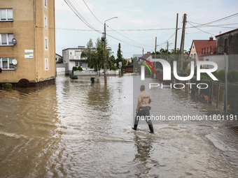 A man walks in the water after Nysa Klodzka river flooded town of Lewin Brzeski in southwestern Poland, on September 19th, 2024. Storm Boris...