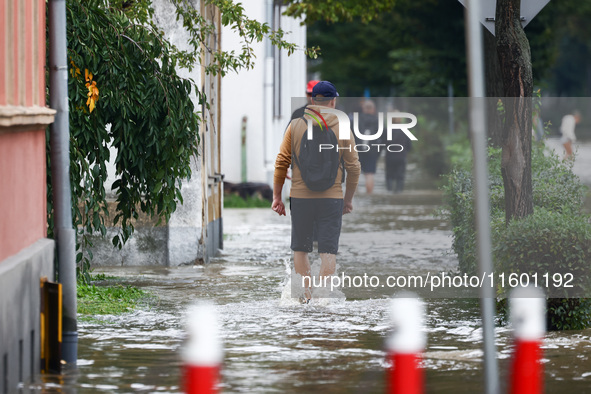 Residents walk in the water after Nysa Klodzka river flooded town of Lewin Brzeski in southwestern Poland, on September 19th, 2024. Storm Bo...