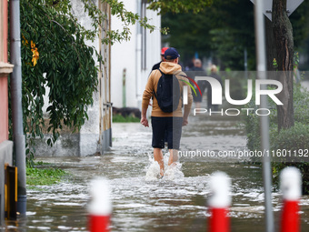 Residents walk in the water after Nysa Klodzka river flooded town of Lewin Brzeski in southwestern Poland, on September 19th, 2024. Storm Bo...