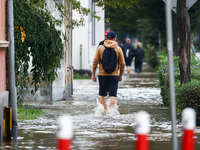 Residents walk in the water after Nysa Klodzka river flooded town of Lewin Brzeski in southwestern Poland, on September 19th, 2024. Storm Bo...