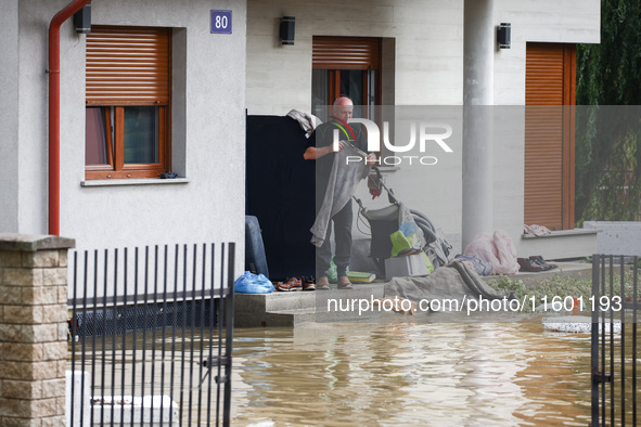 A resident is seen outside a hosue after Nysa Klodzka river flooded town of Lewin Brzeski in southwestern Poland, on September 19th, 2024. S...