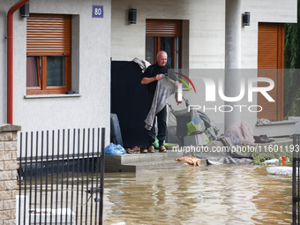 A resident is seen outside a hosue after Nysa Klodzka river flooded town of Lewin Brzeski in southwestern Poland, on September 19th, 2024. S...