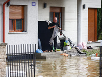 A resident is seen outside a hosue after Nysa Klodzka river flooded town of Lewin Brzeski in southwestern Poland, on September 19th, 2024. S...