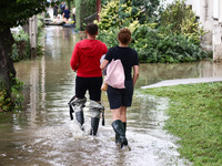 Residents walk in the water after Nysa Klodzka river flooded town of Lewin Brzeski in southwestern Poland, on September 19th, 2024. Storm Bo...