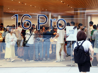 Customers experience Apple's new flagship mobile phone, the iPhone 16, at the largest Apple flagship store in Asia in Shanghai, China, on Se...