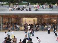 Customers experience Apple's new flagship mobile phone, the iPhone 16, at the largest Apple flagship store in Asia in Shanghai, China, on Se...