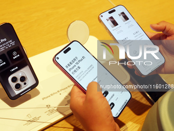 Customers experience Apple's new flagship mobile phone, the iPhone 16, at the largest Apple flagship store in Asia in Shanghai, China, on Se...