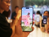 Customers experience Apple's new flagship mobile phone, the iPhone 16, at the largest Apple flagship store in Asia in Shanghai, China, on Se...