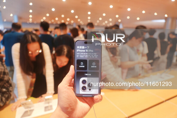 Customers experience Apple's new flagship mobile phone, the iPhone 16, at the largest Apple flagship store in Asia in Shanghai, China, on Se...