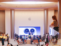 Customers experience Apple's new flagship mobile phone, the iPhone 16, at the largest Apple flagship store in Asia in Shanghai, China, on Se...