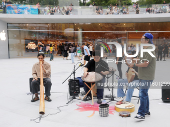 Customers experience Apple's new flagship mobile phone, the iPhone 16, at the largest Apple flagship store in Asia in Shanghai, China, on Se...