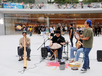 Customers experience Apple's new flagship mobile phone, the iPhone 16, at the largest Apple flagship store in Asia in Shanghai, China, on Se...