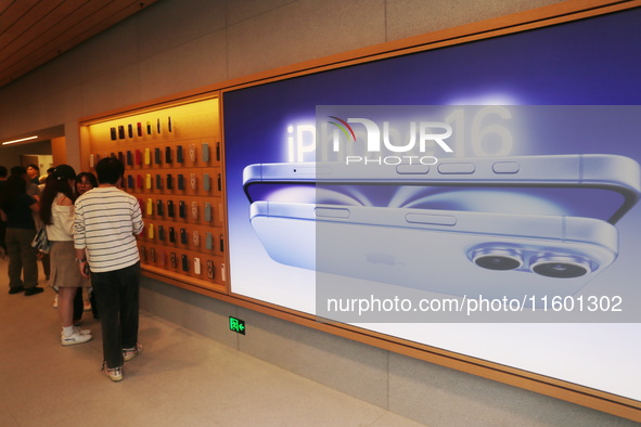 Customers experience Apple's new flagship mobile phone, the iPhone 16, at the largest Apple flagship store in Asia in Shanghai, China, on Se...