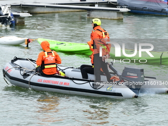 Sea rescuers on a boat monitor the descent on the Saone of the Lyon Kayak in Lyon, France, on September 22, 2024. (