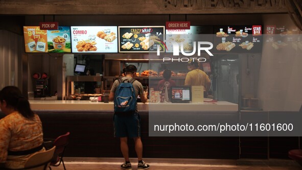 Customers purchase food at the Texas Chicken restaurant on Silom Road in Bangkok, Thailand, on September 23, 2024. Texas Chicken, the intern...