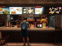 Customers purchase food at the Texas Chicken restaurant on Silom Road in Bangkok, Thailand, on September 23, 2024. Texas Chicken, the intern...