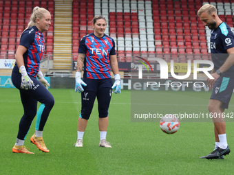 Milla-Maj Majasaari of Crystal Palace Women, Shae Yanez of Crystal Palace, and Goalkeeping Coach Daniel Matraszek participate in the pre-mat...