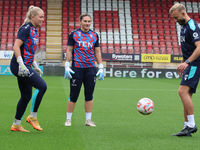 Milla-Maj Majasaari of Crystal Palace Women, Shae Yanez of Crystal Palace, and Goalkeeping Coach Daniel Matraszek participate in the pre-mat...