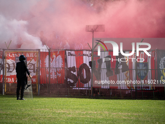 Resovia fans attend the game between Hutnik Krakow and Resovia Rzeszow in Krakow, Poland, on September 22, 2024. Team supporters burn smoke...