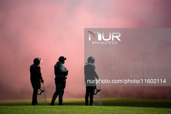 Resovia fans attend the game between Hutnik Krakow and Resovia Rzeszow in Krakow, Poland, on September 22, 2024. Team supporters burn smoke...