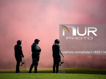 Resovia fans attend the game between Hutnik Krakow and Resovia Rzeszow in Krakow, Poland, on September 22, 2024. Team supporters burn smoke...