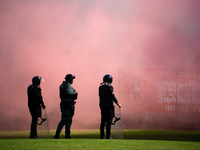 Resovia fans attend the game between Hutnik Krakow and Resovia Rzeszow in Krakow, Poland, on September 22, 2024. Team supporters burn smoke...