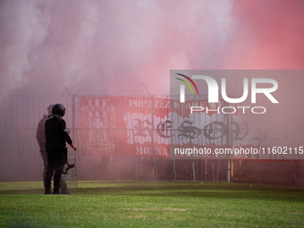 Resovia fans attend the game between Hutnik Krakow and Resovia Rzeszow in Krakow, Poland, on September 22, 2024. Team supporters burn smoke...