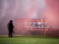 Resovia fans attend the game between Hutnik Krakow and Resovia Rzeszow in Krakow, Poland, on September 22, 2024. Team supporters burn smoke...