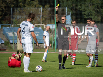 Referee Filip Kaliszewski shows a yellow card to Lukasz Kedziora during the game between Hutnik Krakow and Resovia Rzeszow in Krakow, Poland...