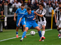 Francis McTominay of SSC Napoli battles for the ball with Kenan Yildiz of Juventus during the Serie A match between Juventus and Napoli at A...