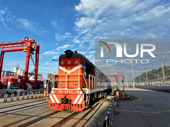 A China-Europe freight train is loaded with containers as it prepares to depart at the China-Kazakhstan (Lianyungang) Logistics Cooperation...