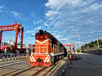 A China-Europe freight train is loaded with containers as it prepares to depart at the China-Kazakhstan (Lianyungang) Logistics Cooperation...