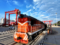 A China-Europe freight train is loaded with containers as it prepares to depart at the China-Kazakhstan (Lianyungang) Logistics Cooperation...